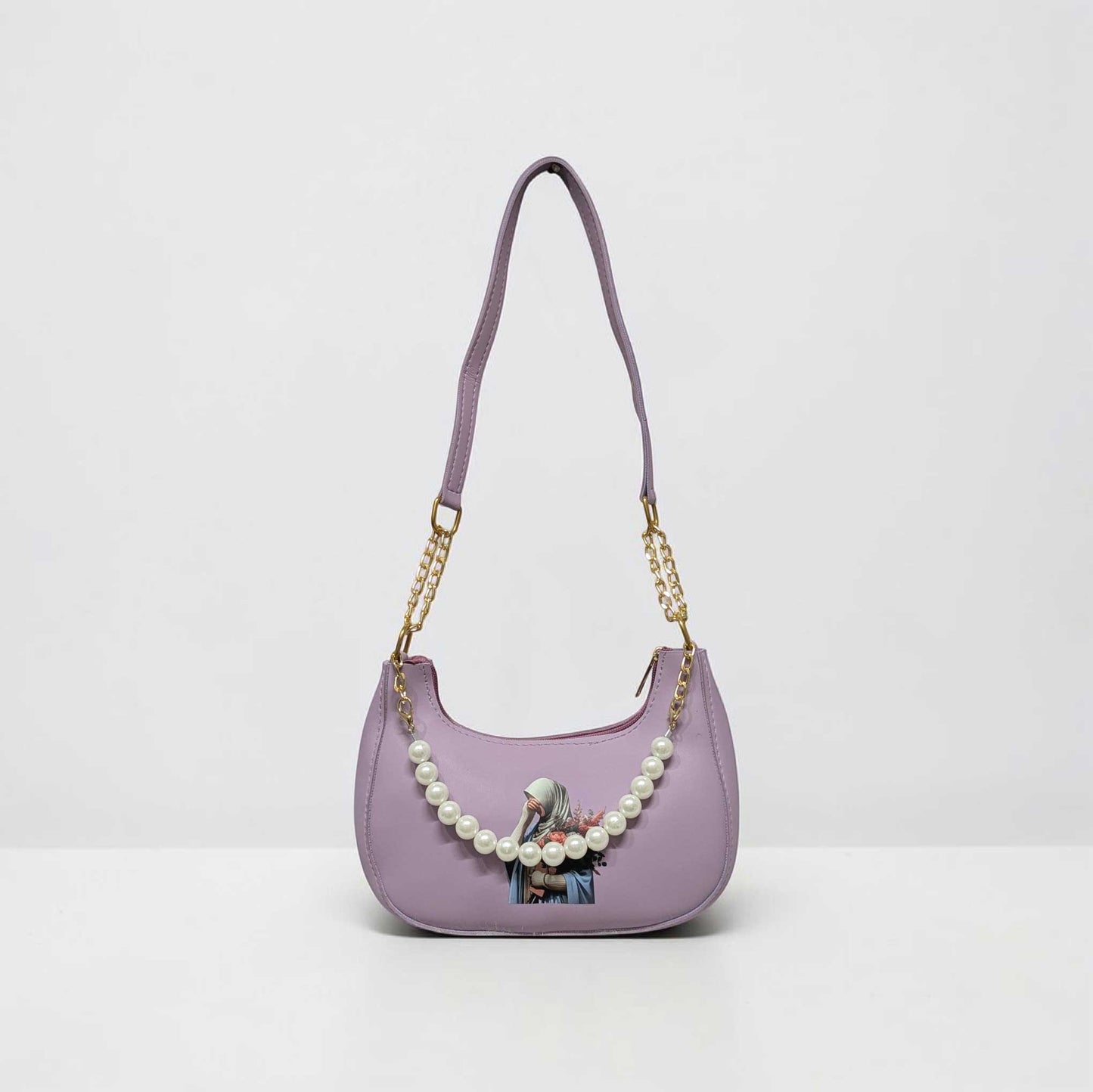 Purple handbag with pearl chain and printed design on a white background