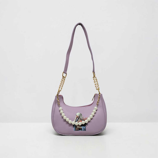 Purple handbag with pearl chain and printed design on a white background