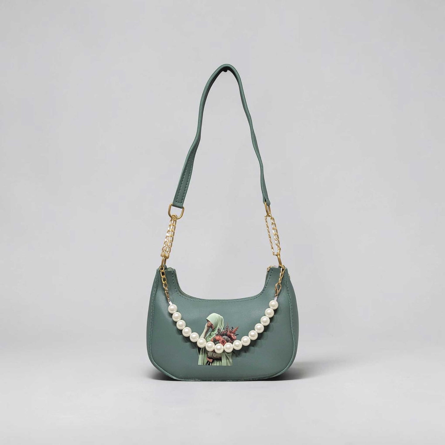 Green handbag with pearl chain on a light gray background