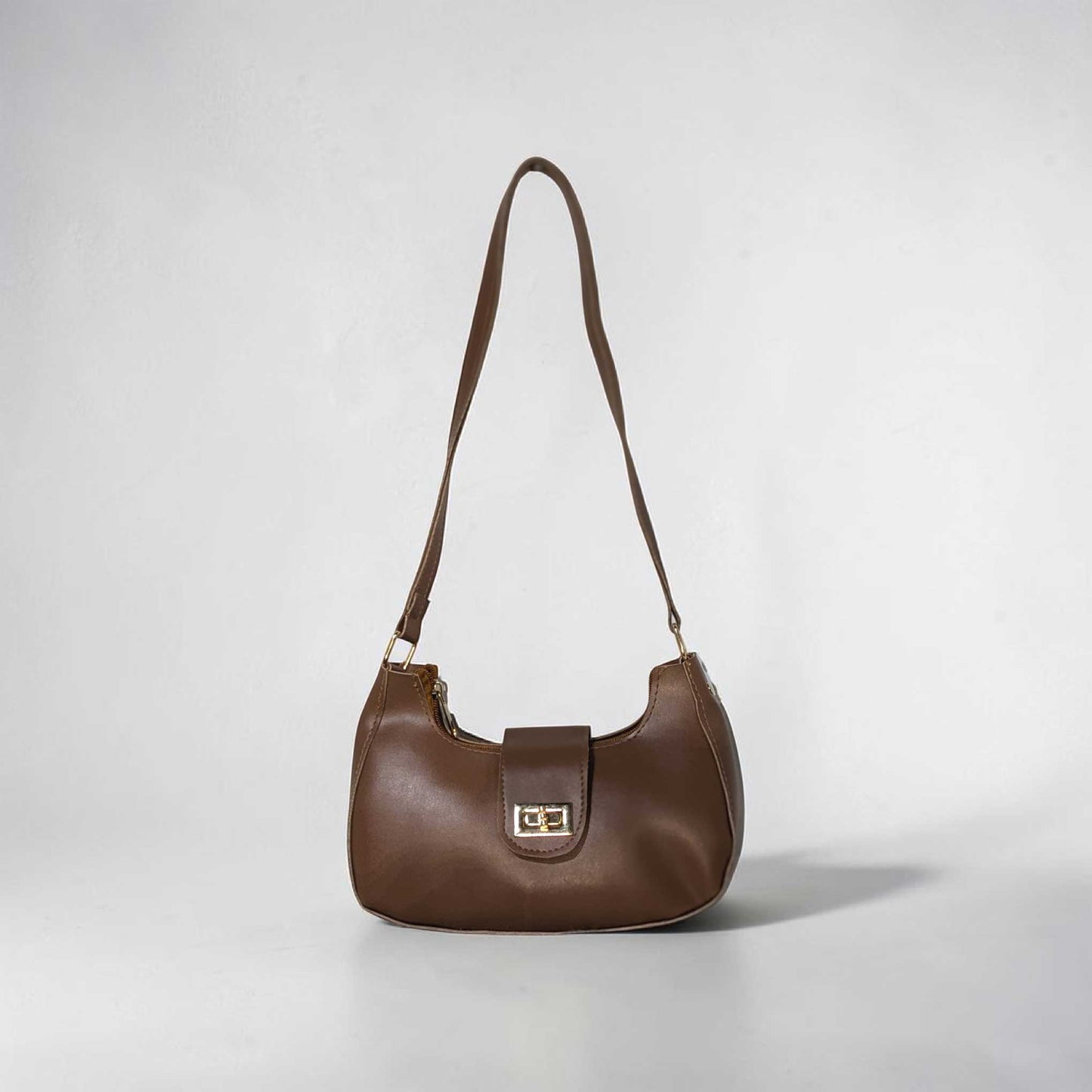 Brown handbag on a light gray background